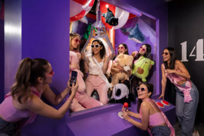Groupe d’amies célébrant un EVJF dans le décor machine à pinces immersive de KONEO Studio à Paris.